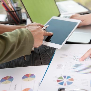 Image of two young woman business using touchpad at meeting.
business team meeting to discuss statistical data presented in the form of digital graphs and charts.